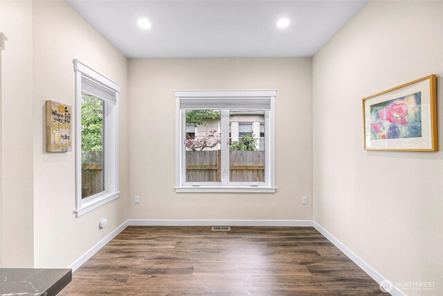 empty room with dark wood-style flooring, baseboards, recessed lighting, and visible vents