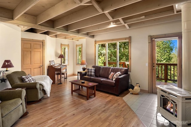 living room featuring baseboards, light wood-style flooring, and beam ceiling