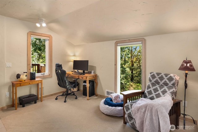 office area featuring carpet floors, baseboards, visible vents, and lofted ceiling