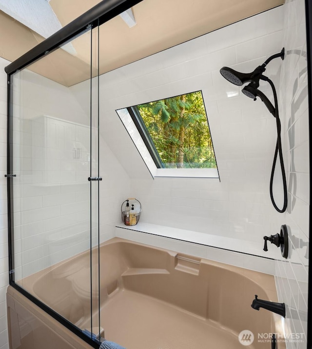 full bathroom with bath / shower combo with glass door