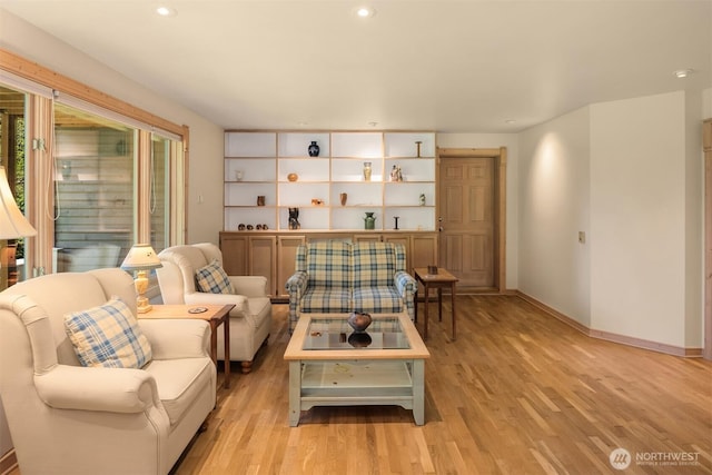 living area featuring light wood-style floors, recessed lighting, and baseboards