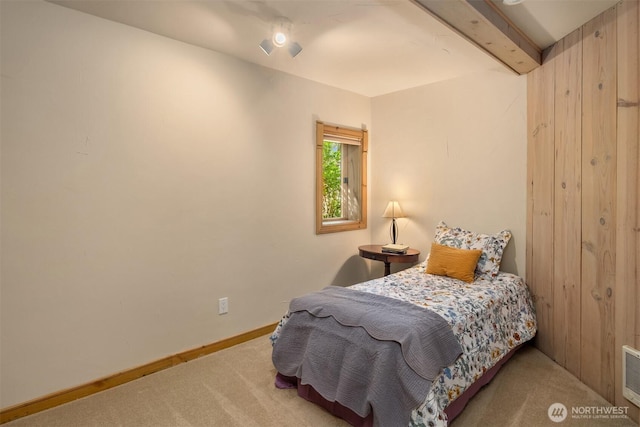 bedroom featuring baseboards, carpet flooring, and beamed ceiling