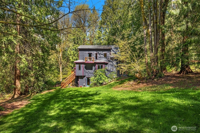 view of yard featuring stairway and a forest view