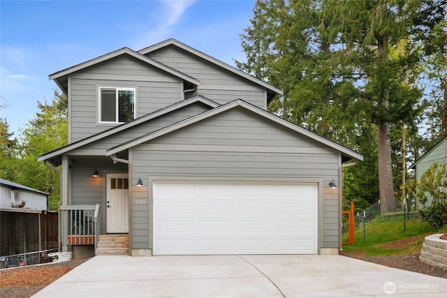 view of front of property with a garage, driveway, and fence