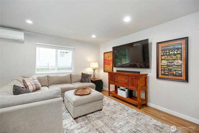 living room with baseboards, wood finished floors, an AC wall unit, and recessed lighting