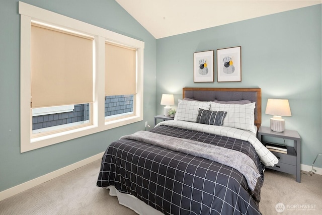 bedroom featuring vaulted ceiling, baseboards, and light carpet