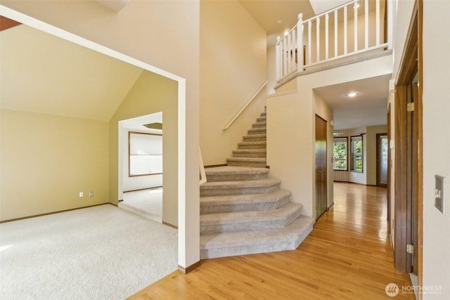 13233 W 44th Ave W, Mukilteo, WA 98275 - stairway featuring wood finished floors, high vaulted ceiling, and baseboards