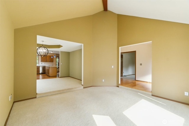 13233 W 44th Ave W, Mukilteo, WA 98275 - carpeted empty room with high vaulted ceiling, a chandelier, baseboards, and beam ceiling