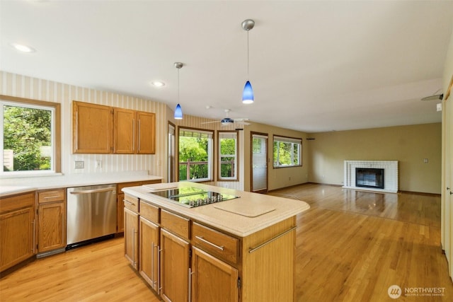 13233 W 44th Ave W, Mukilteo, WA 98275 - kitchen with stainless steel dishwasher, black electric cooktop, light wood-type flooring, light countertops, and a kitchen island