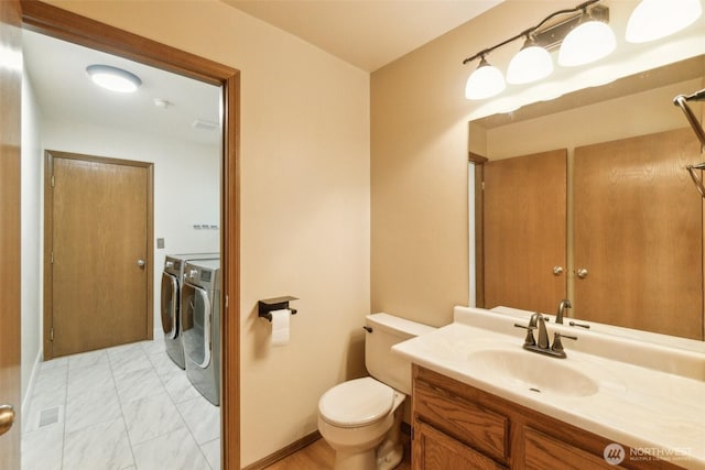 13233 W 44th Ave W, Mukilteo, WA 98275 - bathroom with washer and clothes dryer, marble finish flooring, toilet, and vanity