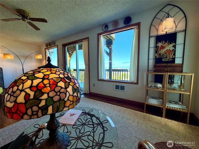 1311 Ocean Shores Blvd SW Unit 3, Ocean Shores, WA 98569 - bedroom featuring access to exterior, multiple windows, a textured ceiling, and wood finished floors
