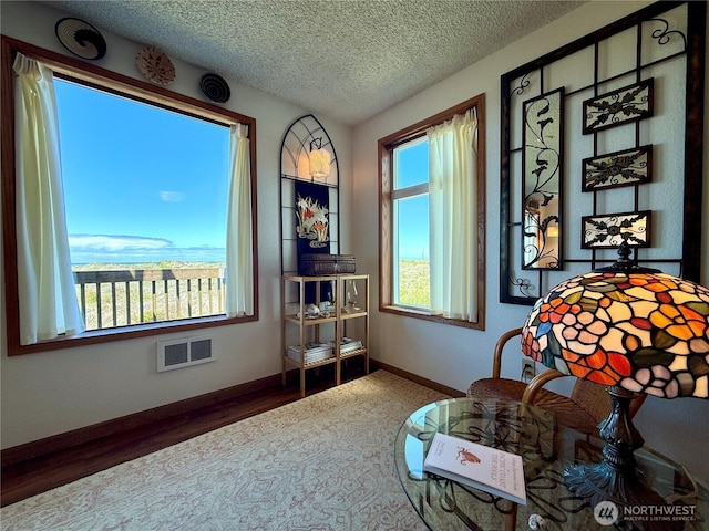 1311 Ocean Shores Blvd SW Unit 3, Ocean Shores, WA 98569 - sitting room featuring wood finished floors and a textured ceiling
