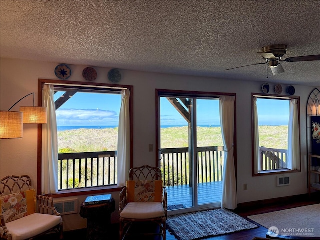 1311 Ocean Shores Blvd SW Unit 3, Ocean Shores, WA 98569 - entryway with a textured ceiling, healthy amount of natural light, a ceiling fan, and wood finished floors