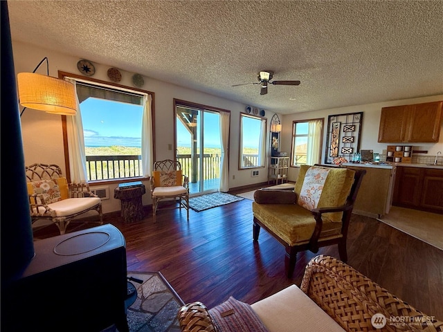 1311 Ocean Shores Blvd SW Unit 3, Ocean Shores, WA 98569 - living room featuring dark wood finished floors, ceiling fan, and a textured ceiling