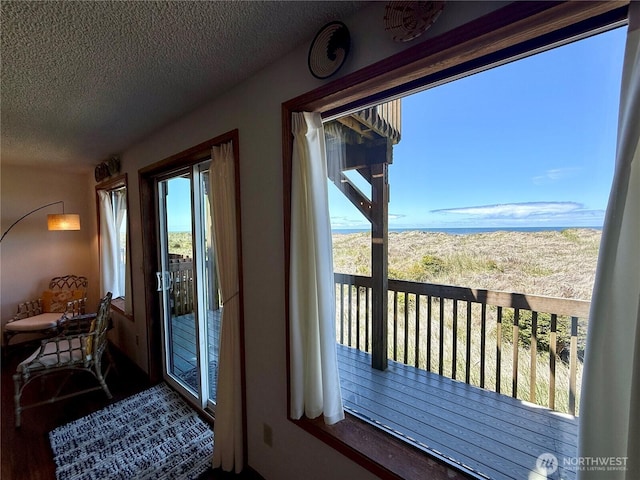 1311 Ocean Shores Blvd SW Unit 3, Ocean Shores, WA 98569 - doorway to outside featuring a textured ceiling and wood finished floors