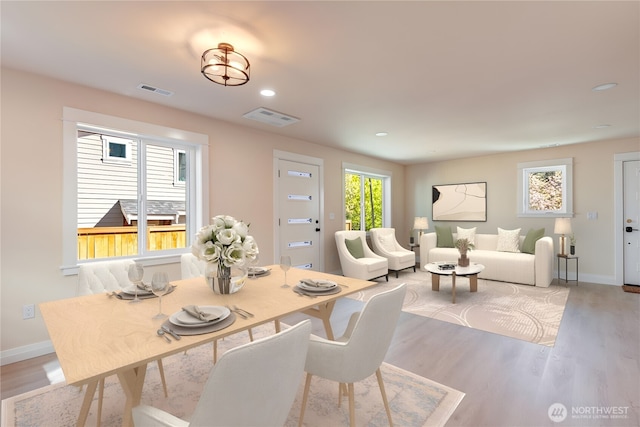 dining space featuring light wood-style floors, baseboards, and recessed lighting