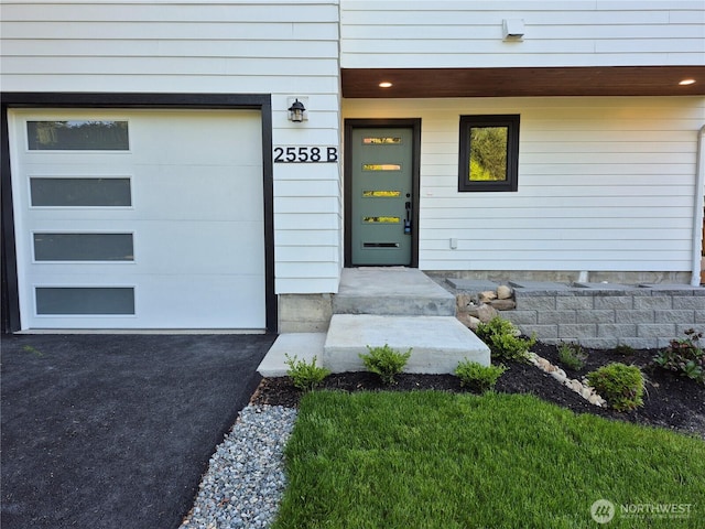 2558 NE 91st St Unit B, Seattle, WA 98115 - view of exterior entry with a garage and asphalt driveway