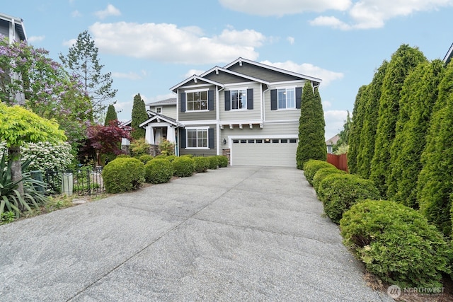 view of front of home with a garage, fence, and driveway