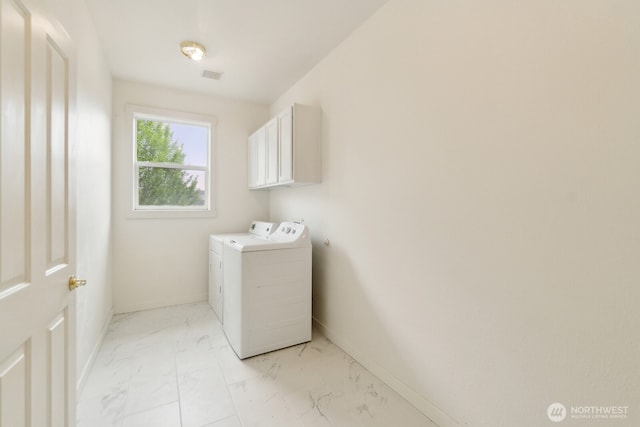 clothes washing area with cabinet space, marble finish floor, baseboards, visible vents, and washer and clothes dryer