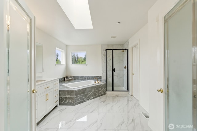 full bath featuring vanity, marble finish floor, a bath, a shower stall, and a skylight