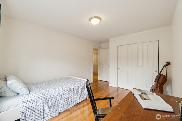 bedroom featuring wood finished floors and a closet