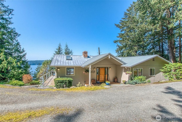519 Highlands Dr, Orcas Island, WA 98245 - view of front of home featuring a chimney, metal roof, and a standing seam roof