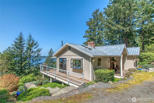 519 Highlands Dr, Orcas Island, WA 98245 - view of front of home with a chimney, metal roof, and a wooden deck