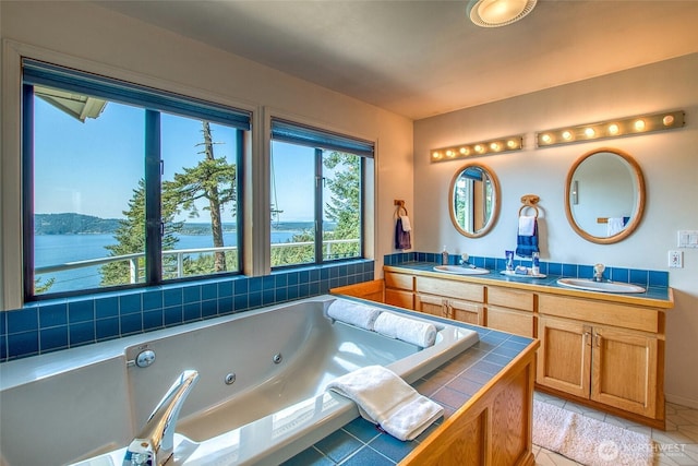 519 Highlands Dr, Orcas Island, WA 98245 - full bathroom featuring a tub with jets, tile patterned flooring, double vanity, and a water view