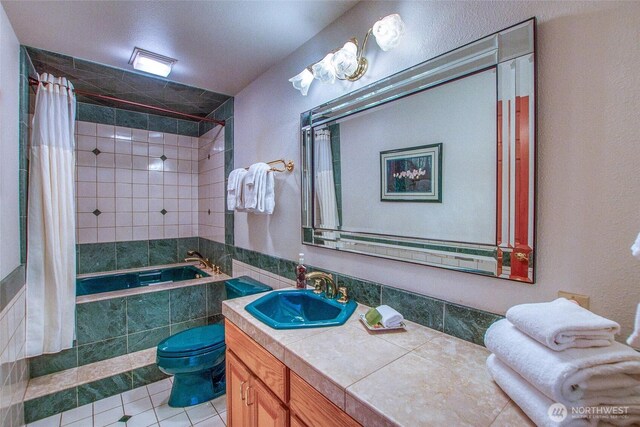 519 Highlands Dr, Orcas Island, WA 98245 - bathroom featuring tiled shower / bath, tile patterned floors, vanity, and toilet