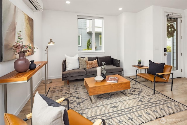 living room with baseboards, wood finished floors, recessed lighting, and a wall mounted air conditioner
