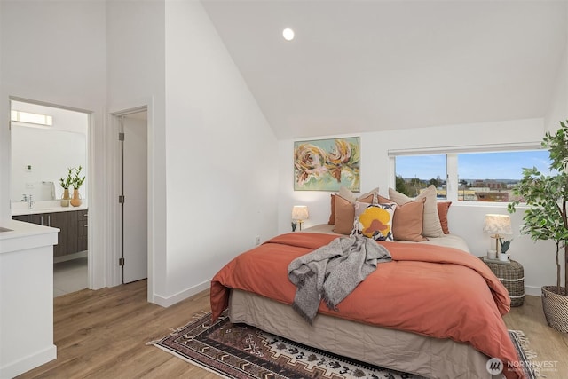 bedroom featuring recessed lighting, connected bathroom, light wood-style floors, baseboards, and high vaulted ceiling