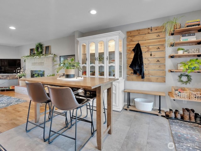 dining space with a fireplace and recessed lighting