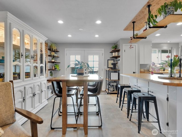 dining space featuring recessed lighting, french doors, and light tile patterned floors