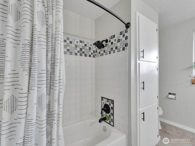 bathroom with toilet, baseboards, and shower / bath combination with curtain