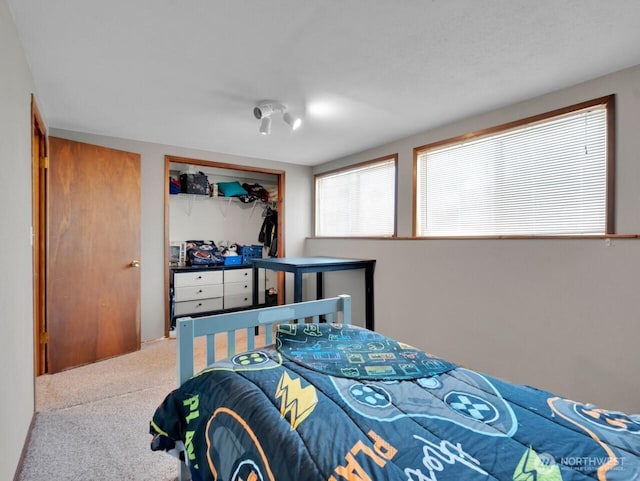 carpeted bedroom featuring a closet