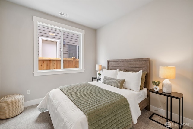carpeted bedroom featuring baseboards and visible vents