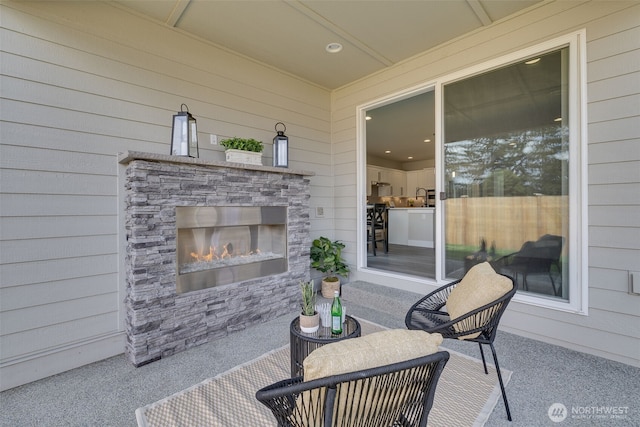 view of patio / terrace featuring an outdoor stone fireplace
