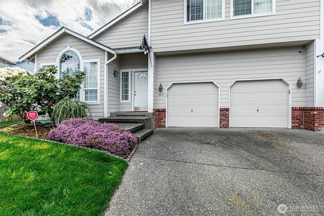 14231 SE 282nd St, Kent, WA 98042 - view of front of house with aphalt driveway, brick siding, and a garage