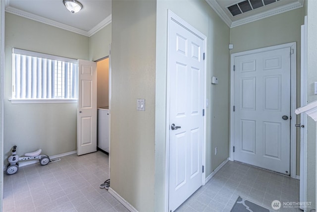 14231 SE 282nd St, Kent, WA 98042 - corridor with baseboards, visible vents, ornamental molding, light tile patterned floors, and washer / dryer