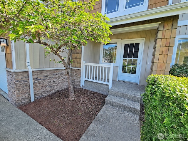 view of exterior entry featuring a porch
