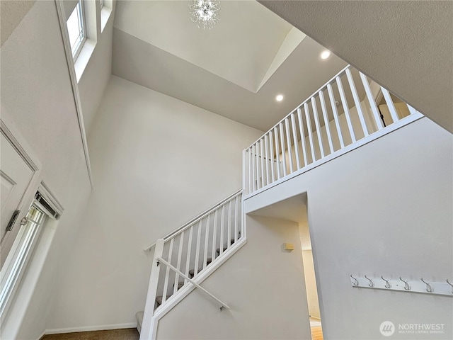 stairs featuring recessed lighting and a high ceiling