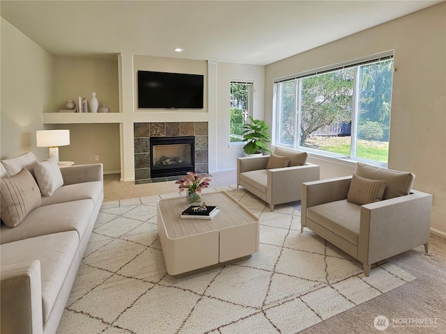 living room with recessed lighting, baseboards, a fireplace, and light carpet