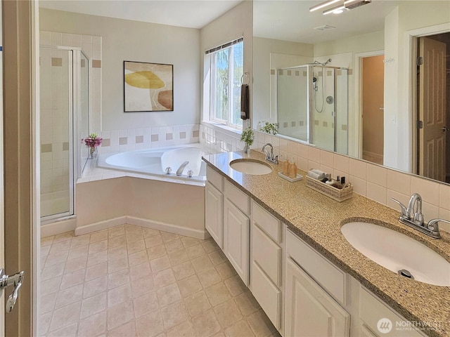 full bathroom with a sink, a stall shower, and a garden tub
