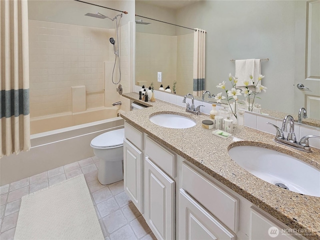 bathroom with a sink, tile patterned floors, shower / bath combo, and toilet