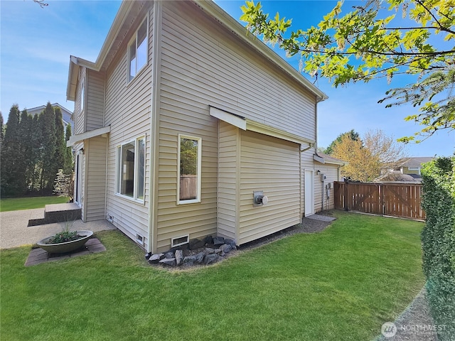 back of property with a yard and fence