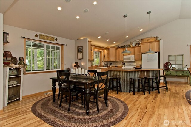 25012 67th Ave E, Graham, WA 98338 - dining area featuring vaulted ceiling, a healthy amount of sunlight, light wood finished floors, and recessed lighting