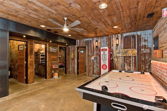 25012 67th Ave E, Graham, WA 98338 - recreation room featuring wooden ceiling, wooden walls, concrete floors, and a ceiling fan