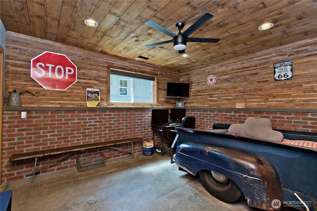 25012 67th Ave E, Graham, WA 98338 - bedroom featuring wood ceiling, concrete flooring, wooden walls, and recessed lighting