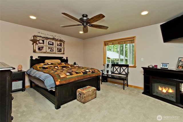 25012 67th Ave E, Graham, WA 98338 - bedroom with light carpet, baseboards, a glass covered fireplace, and recessed lighting