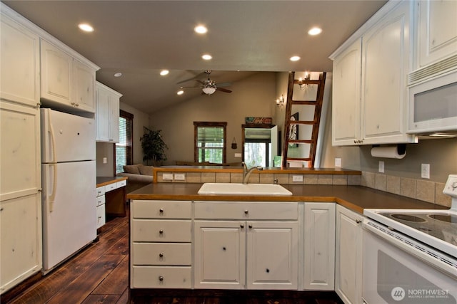 25012 67th Ave E, Graham, WA 98338 - kitchen featuring a peninsula, a sink, open floor plan, white appliances, and dark wood-type flooring